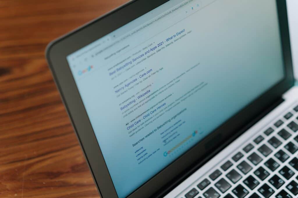 Laptop displaying search engine results page for SEO services.